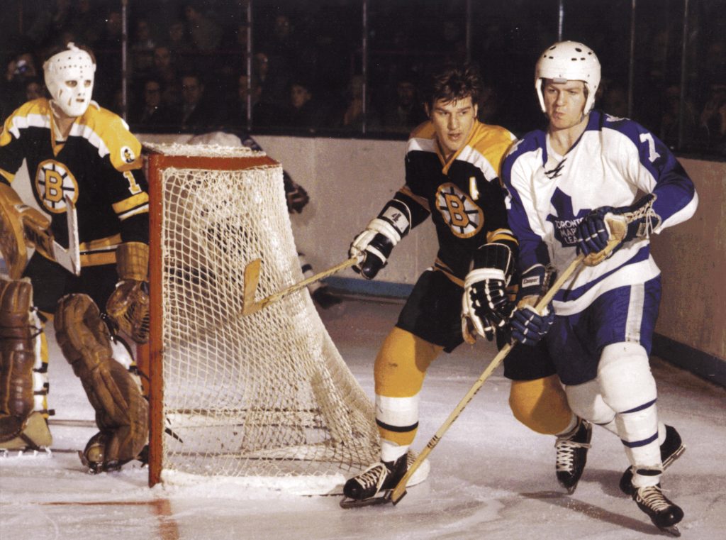 Bobby Orr behind the net playing hockey.