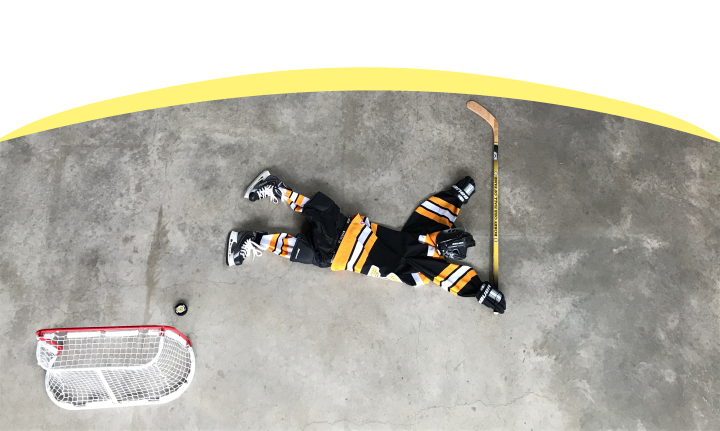 Hockey net with puck, character made from jersey, skates, hockey stick and helmet mimic